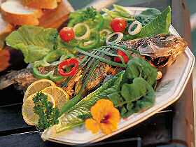 BBQ whole fish and salad dish with garnish
